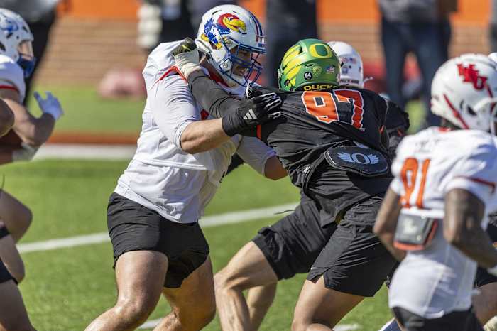 Jan 30, 2024; Mobile, AL, USA; National offensive lineman Dominick Puni of Kansas (71) battles National defensive lineman Brandon Dorlus of Oregon (97) during practice for the National team at Hancock Whitney Stadium. Mandatory Credit: Vasha Hunt-USA TODAY Sports  
